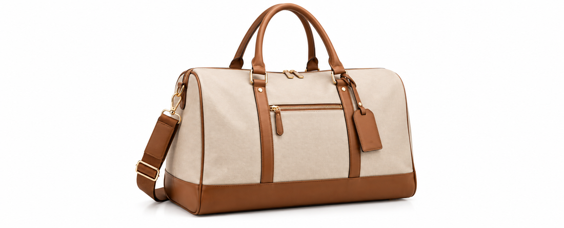 Elegant beige and brown travel bag with leather trim, gold hardware, top handles, and shoulder strap displayed on a clean white background.